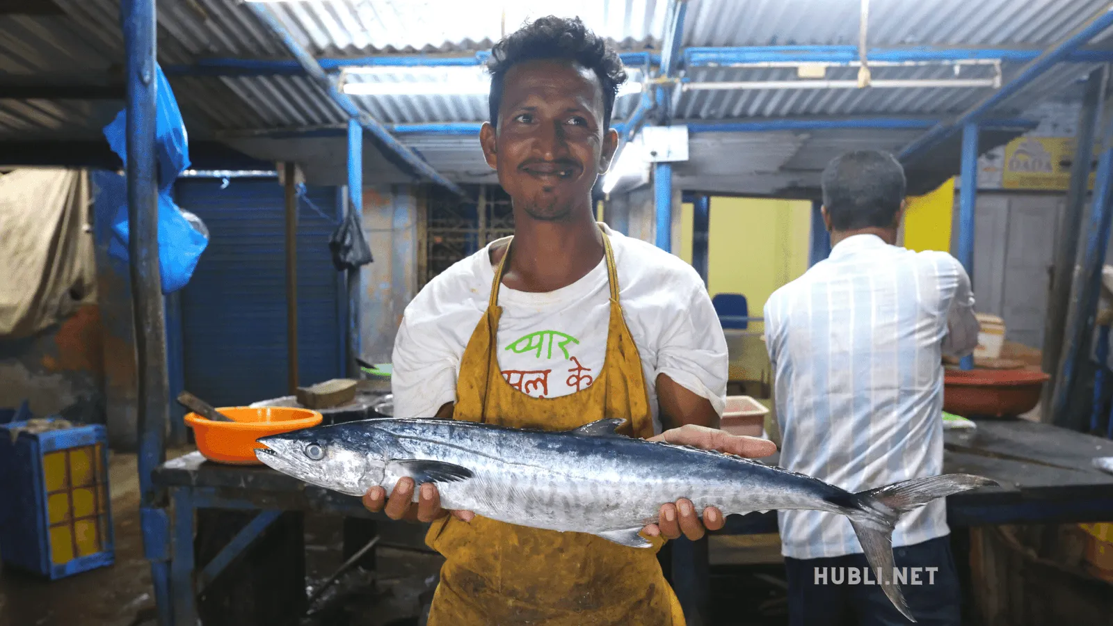 A friendly shop keeper posing with a King Fish (Surmai)